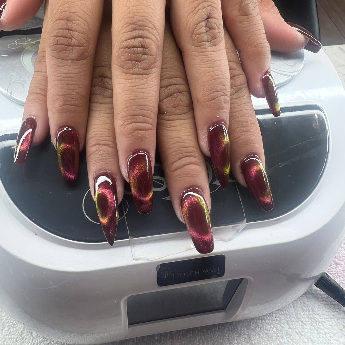 Glossy burgundy coffin nails with chrome accent nail art from SD Nails & Spa, Seattle